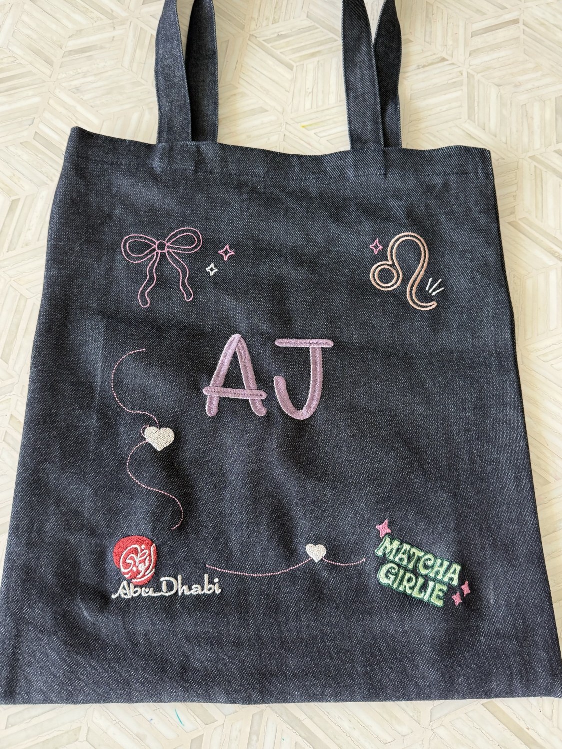 Denim tote embroidered with initials and individual motifs